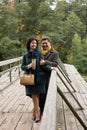 Expression of feelings. Mature couple walking on the wooden bridge. Casual wear. True love.