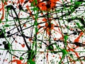 Expressionism. red black green paint splattered with lines and drops on a white surface