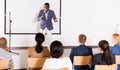 Expressive african american speaker with microphone on conference room stage Royalty Free Stock Photo