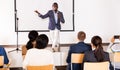 Expressive african american speaker with microphone on conference room stage Royalty Free Stock Photo