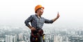 Expressive blonde woman in workwear and hardhat