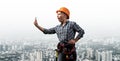 Expressive blonde woman in workwear and hardhat