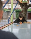 Expressive boy playing and battling table air hockey at fair against a friend Royalty Free Stock Photo