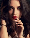 Expressive bright makeup woman touching finger her red lips with Royalty Free Stock Photo