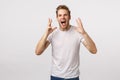 Expressive charismatic happy young man sharing his happiness with world, shaking hands feeling luck and upbeat, shouting Royalty Free Stock Photo