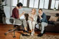 Expressive couple talking to attentive psychotherapist in her cabinet