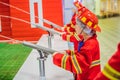 Expressive cute toddler with fireman`s outfit playing fireman Royalty Free Stock Photo