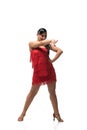 Dancer looking away and pointing with finger while performing tango on white background