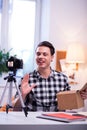 Expressive dark-haired man being involved in recording video