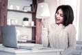 Expressive dark-haired woman being very happy with information