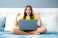 Expressive emotional excited teen girl. Teenager child girl working on laptop pc computer lying in bed resting relaxing Royalty Free Stock Photo