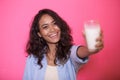Expressive face of asian woman offering a glass of milk Royalty Free Stock Photo