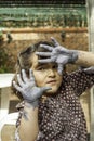 Expressive girl portrait acting with painted hands