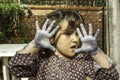 Expressive girl portrait acting with painted hands