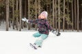 Expressive Girl Sitting on Snow Hill Looking at Camera