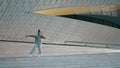 Expressive guy dancing stairs stadium alone. Person performing choreography