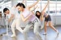 Expressive young girl learning modern street dancing during multinational group class in choreographic studio Royalty Free Stock Photo