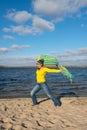 Expressive joyful woman happily goes to meet the wind, having Royalty Free Stock Photo