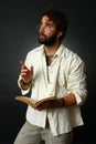 Expressive man gesturing with book Royalty Free Stock Photo