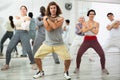 Expressive man learning to dance krump with group in studio Royalty Free Stock Photo