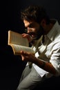Expressive man reading a book Royalty Free Stock Photo