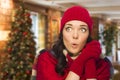 Expressive Mixed Race Girl Wearing Mittens and Hat In Christmas Setting Royalty Free Stock Photo