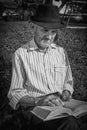 Expressive old farmer holding a book, close-up