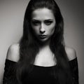 Expressive portrait of brunette woman with mystical look in dark Royalty Free Stock Photo