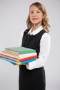 An expressive portrait of a smiling beautiful young schoolgirl with school textbooks. Royalty Free Stock Photo