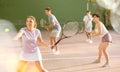 Expressive resolved fit girl playing frontenis ball friendly match on court