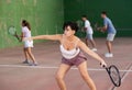 Expressive resolved fit girl playing frontenis ball friendly match on court