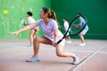 Expressive resolved fit girl playing frontenis ball friendly match on court