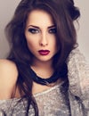 Expressive make-up model posing in grey blouse with modern