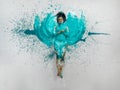 expressive sexy woman lies naked elegant on the floor in turquoise blue color abstract painted bodypainting woman on the splashed