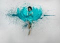 Expressive sexy woman lies naked elegant on the floor in turquoise blue color abstract painted bodypainting woman on the splashed