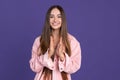 Expressive smile. Cropped portrait of young beautiful woman gesturing on purple background