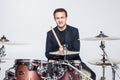 Expressive young drummer playing at the drums with drum stick isolated on white background Royalty Free Stock Photo