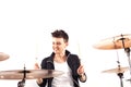 Expressive young drummer playing at the drums with drum stick Royalty Free Stock Photo