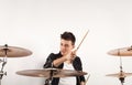 Expressive young drummer playing at the drums with drum stick Royalty Free Stock Photo