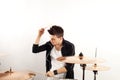 Expressive young drummer playing at the drums with drum stick Royalty Free Stock Photo