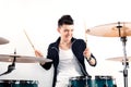 Expressive young drummer playing at the drums with drum stick Royalty Free Stock Photo