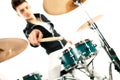 Expressive young drummer playing at the drums with drum stick Royalty Free Stock Photo