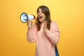 Expressive young girl shout in loudspeaker. Exited woman screaming in megaphone. Big sale, discounts in online store Royalty Free Stock Photo