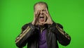 Expressive rocker man screaming and shouting. Studio portrait of handsome person on chroma key Royalty Free Stock Photo