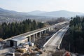 An expressway under construction with a view of the mountains