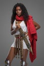Afro-American model in Greek-style tunic with red cape and ornate belt