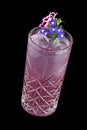 Exquisite cold lemonade with decorative flowers on a dark background