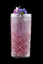 Exquisite cold lemonade with decorative flowers on a dark background