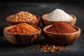 Exquisite collection of spices and seasonings in wooden bowls on dark background