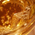 Close up view of a glass of whisky with golden bokeh background